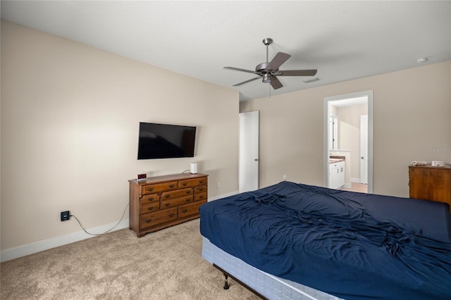 6557 SE 4th Ln, Ocala, FL 34472 - bedroom featuring light carpet, baseboards, ceiling fan, and ensuite bath