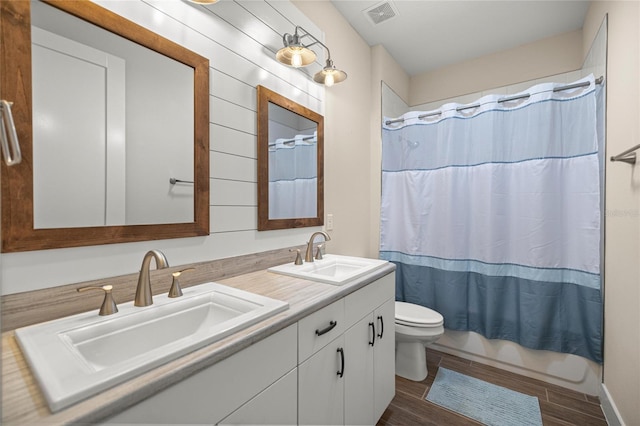 6557 SE 4th Ln, Ocala, FL 34472 - full bath featuring toilet, wood finished floors, double vanity, and shower / bathtub combination with curtain