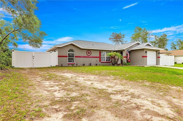 single story home with a gate, an attached garage, stucco siding, and driveway