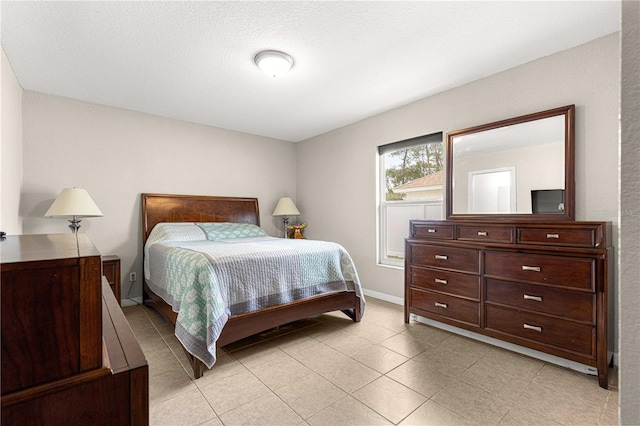bedroom with light tile patterned flooring and baseboards