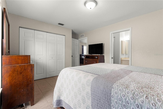 bedroom featuring a closet and light tile patterned floors