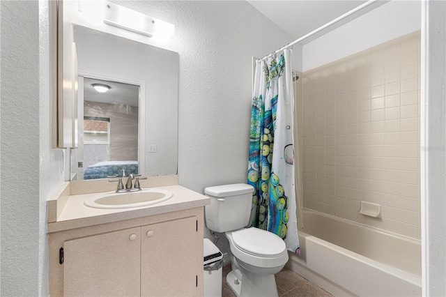 bathroom with a textured wall, vanity, toilet, and shower / bath combo with shower curtain
