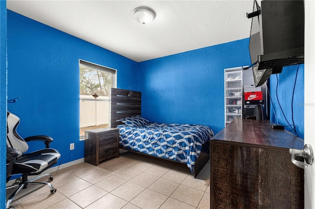 tiled bedroom featuring a textured ceiling