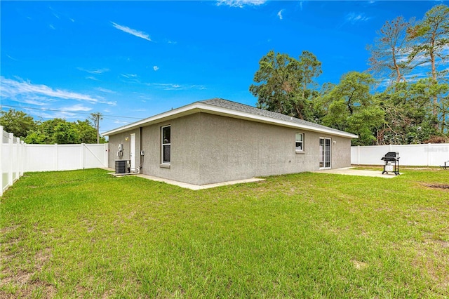 back of property with stucco siding, a patio area, and central air condition unit