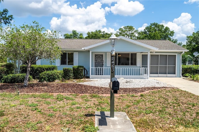8463 SW 108th Pl, Ocala, FL 34481 - single story home featuring covered porch, driveway, roof with shingles, and a garage