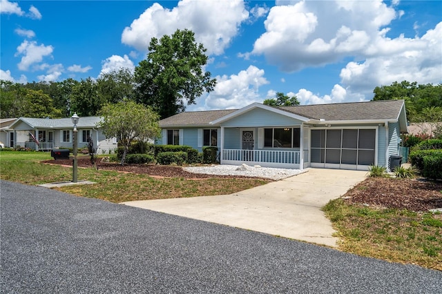 8463 SW 108th Pl, Ocala, FL 34481 - single story home featuring driveway, a garage, covered porch, a front lawn, and a shingled roof