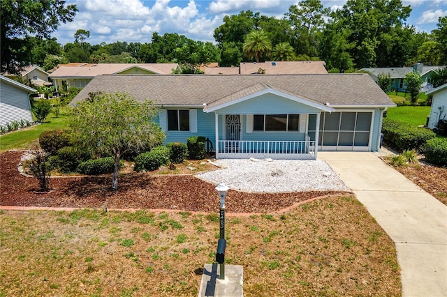 8463 SW 108th Pl, Ocala, FL 34481 - ranch-style house featuring a porch, concrete driveway, and roof with shingles