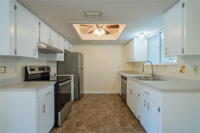 8463 SW 108th Pl, Ocala, FL 34481 - kitchen featuring stainless steel appliances, under cabinet range hood, a ceiling fan, decorative backsplash, and white cabinetry