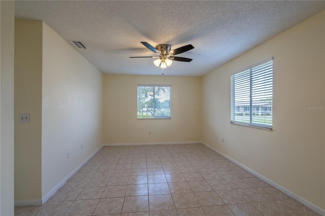 8463 SW 108th Pl, Ocala, FL 34481 - spare room featuring a ceiling fan, a textured ceiling, and light tile patterned floors