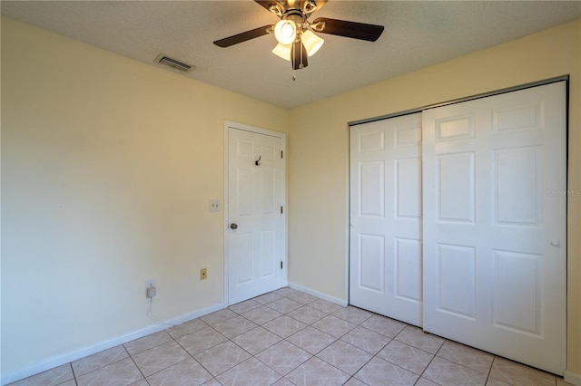 8463 SW 108th Pl, Ocala, FL 34481 - unfurnished bedroom with a closet, light tile patterned flooring, and ceiling fan