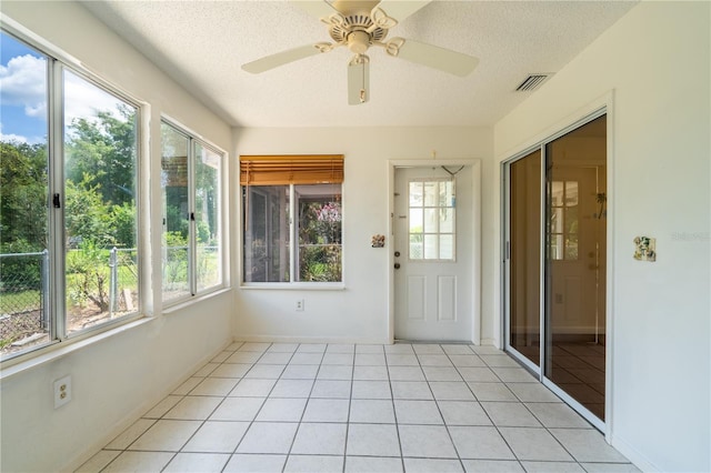 8463 SW 108th Pl, Ocala, FL 34481 - unfurnished sunroom with a textured ceiling and tile patterned flooring