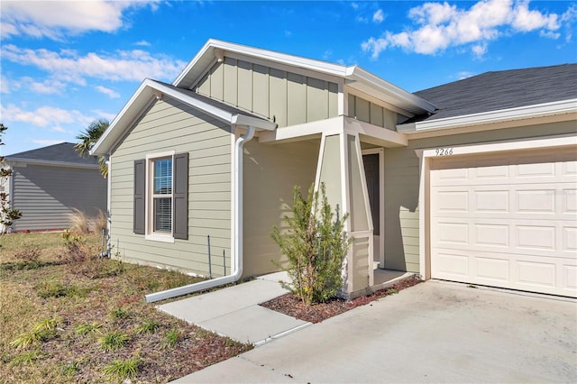 view of front of home featuring board and batten siding, a garage, and driveway