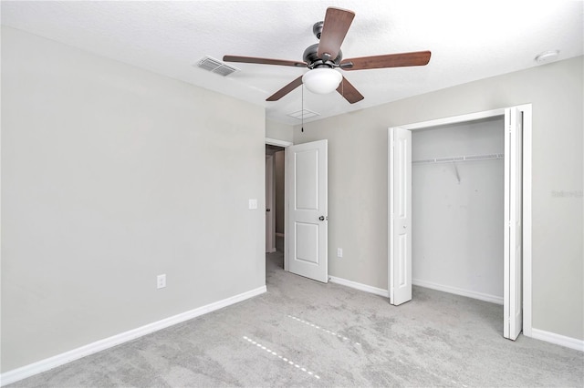 unfurnished bedroom featuring carpet floors, baseboards, a closet, and ceiling fan