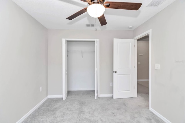 unfurnished bedroom featuring carpet floors, a closet, ceiling fan, and baseboards