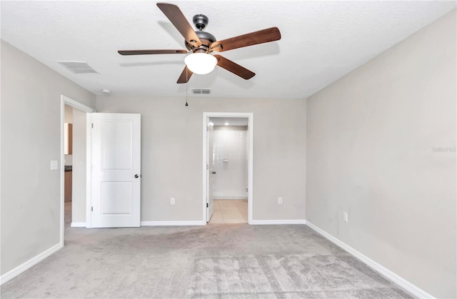 unfurnished bedroom featuring carpet floors, baseboards, connected bathroom, and ceiling fan