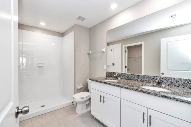 full bathroom featuring tile patterned floors, toilet, a stall shower, double vanity, and recessed lighting