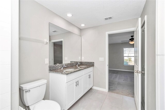 full bathroom featuring toilet, a ceiling fan, baseboards, tile patterned floors, and double vanity