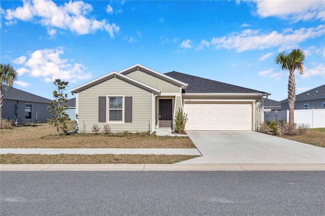single story home with an attached garage, driveway, fence, and board and batten siding