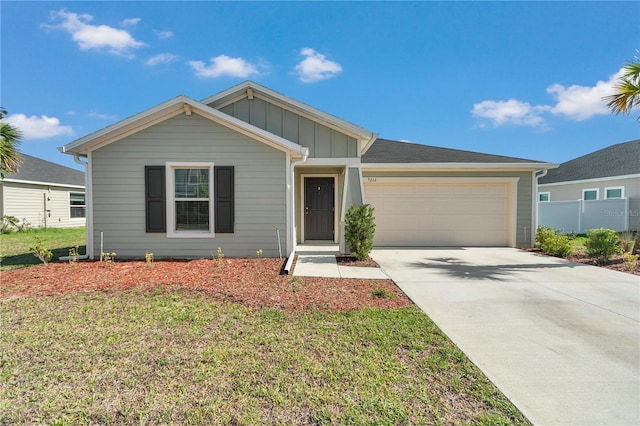9266 SW 58th Cir, Ocala, FL 34476 - single story home with board and batten siding, an attached garage, concrete driveway, and a front lawn