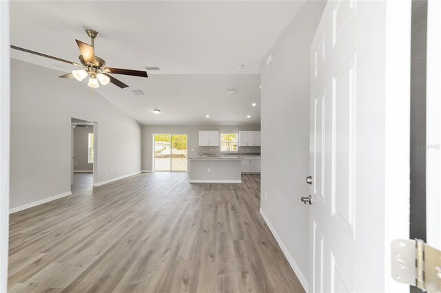 25 Juniper Pass Way, Ocala, FL 34480 - unfurnished living room featuring light wood-type flooring, ceiling fan, baseboards, lofted ceiling, and recessed lighting