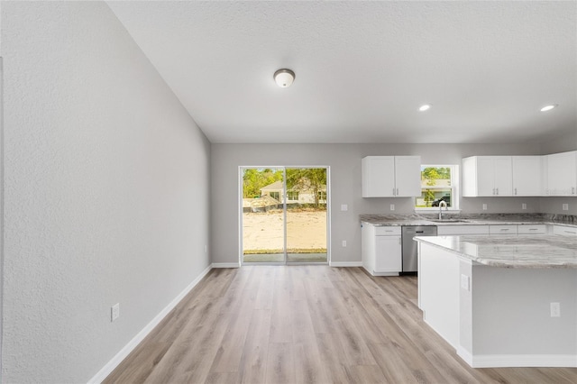 25 Juniper Pass Way, Ocala, FL 34480 - kitchen featuring dishwasher, light wood finished floors, a sink, light stone countertops, and recessed lighting