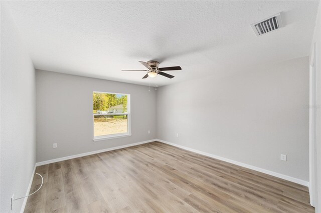 25 Juniper Pass Way, Ocala, FL 34480 - spare room featuring ceiling fan, light wood-type flooring, baseboards, and a textured ceiling