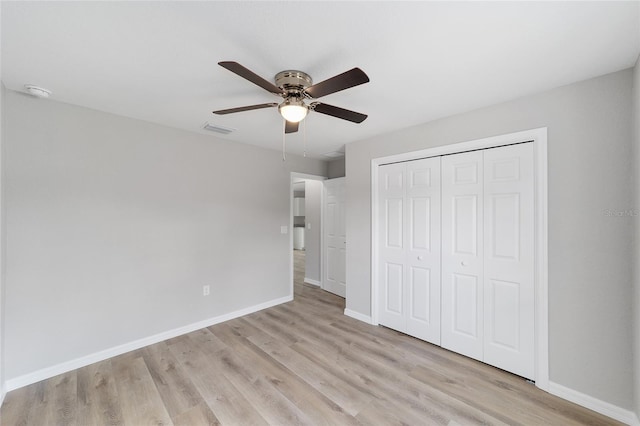 25 Juniper Pass Way, Ocala, FL 34480 - unfurnished bedroom with light wood finished floors, baseboards, a closet, and ceiling fan