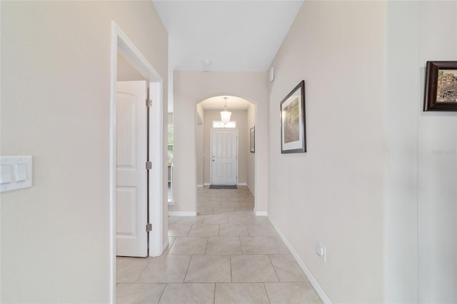 5653 SW 50th Ter, Ocala, FL 34474 - hallway with arched walkways, light tile patterned flooring, and baseboards