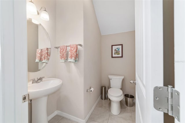 5653 SW 50th Ter, Ocala, FL 34474 - bathroom featuring toilet, a sink, tile patterned flooring, and lofted ceiling