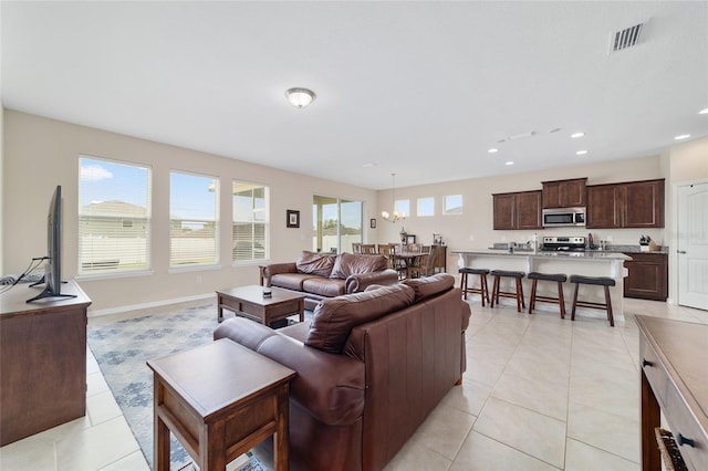 5653 SW 50th Ter, Ocala, FL 34474 - living room with light tile patterned flooring, recessed lighting, a chandelier, and baseboards