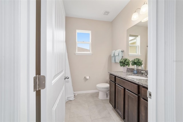 5653 SW 50th Ter, Ocala, FL 34474 - bathroom with toilet, vanity, baseboards, and tile patterned flooring