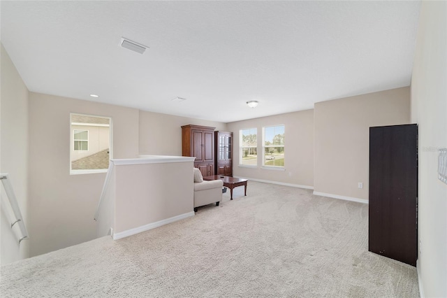 5653 SW 50th Ter, Ocala, FL 34474 - living area featuring an upstairs landing, light carpet, and baseboards