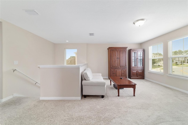 5653 SW 50th Ter, Ocala, FL 34474 - living area featuring an upstairs landing, light colored carpet, and baseboards