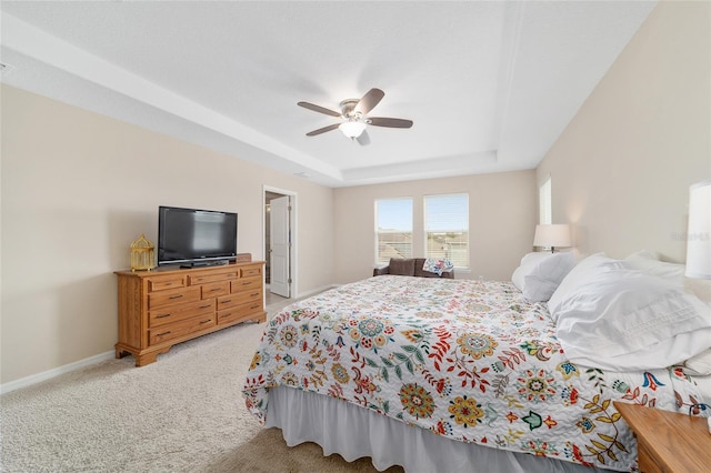 5653 SW 50th Ter, Ocala, FL 34474 - bedroom featuring a raised ceiling, light colored carpet, baseboards, and ceiling fan