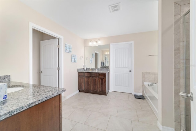 5653 SW 50th Ter, Ocala, FL 34474 - full bathroom with baseboards, tile patterned floors, two vanities, and a shower stall