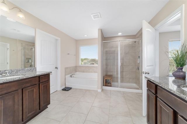 5653 SW 50th Ter, Ocala, FL 34474 - bathroom with a stall shower, healthy amount of natural light, tile patterned flooring, and two vanities