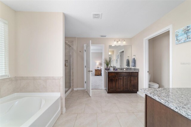 5653 SW 50th Ter, Ocala, FL 34474 - full bathroom with toilet, a stall shower, a bath, vanity, and tile patterned floors