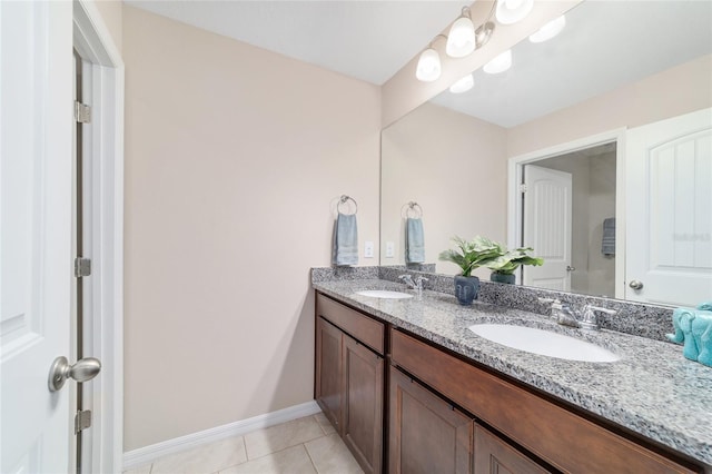 5653 SW 50th Ter, Ocala, FL 34474 - full bathroom featuring tile patterned flooring, double vanity, and baseboards