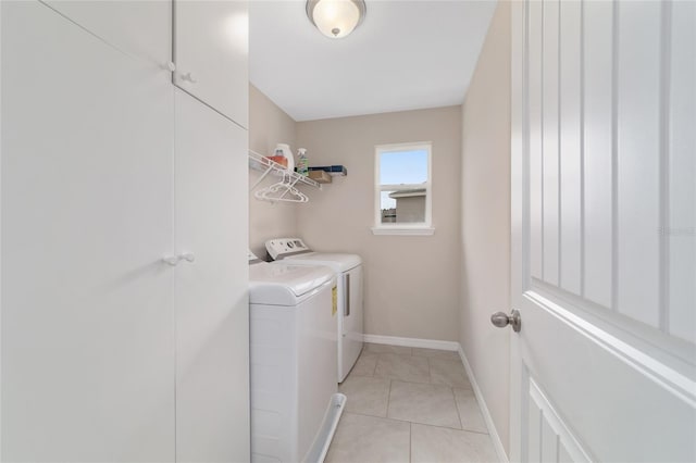 5653 SW 50th Ter, Ocala, FL 34474 - washroom with washing machine and dryer, light tile patterned floors, and baseboards
