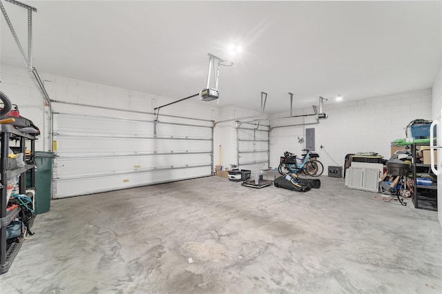 5653 SW 50th Ter, Ocala, FL 34474 - garage with concrete block wall, a garage door opener, and electric panel