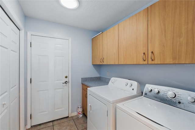 22189 SW Neptune Blvd, Dunnellon, FL 34431 - laundry area with cabinet space, washing machine and dryer, and light tile patterned flooring
