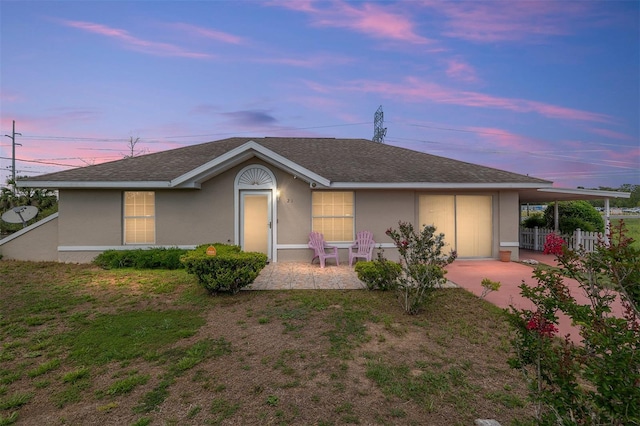 single story home featuring stucco siding, fence, and a patio