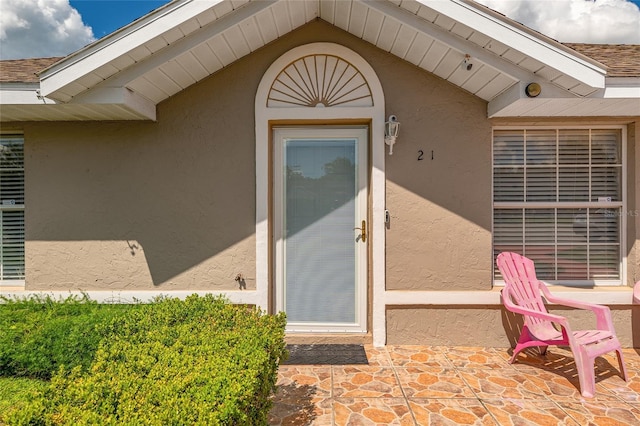 entrance to property with stucco siding