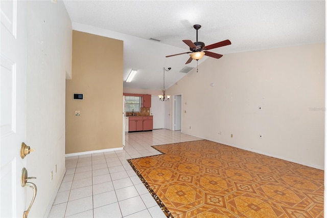 unfurnished room with ceiling fan, a chandelier, light tile patterned flooring, vaulted ceiling, and a sink