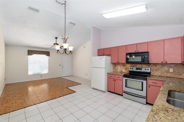 kitchen with black microwave, stainless steel range with electric cooktop, freestanding refrigerator, a chandelier, and red cabinets