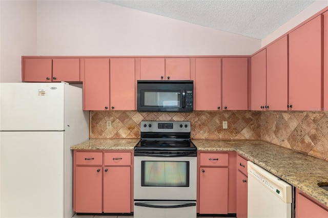 kitchen featuring white appliances, red cabinetry, tasteful backsplash, lofted ceiling, and a textured ceiling