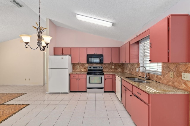 kitchen with white appliances, a sink, vaulted ceiling, a textured ceiling, and red cabinets