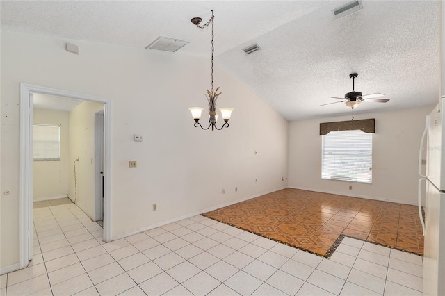 spare room featuring a textured ceiling, ceiling fan, a chandelier, baseboards, and light tile patterned floors