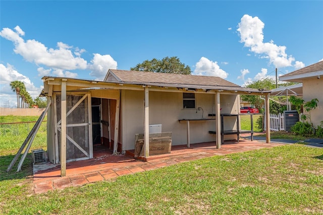 rear view of property featuring central air condition unit
