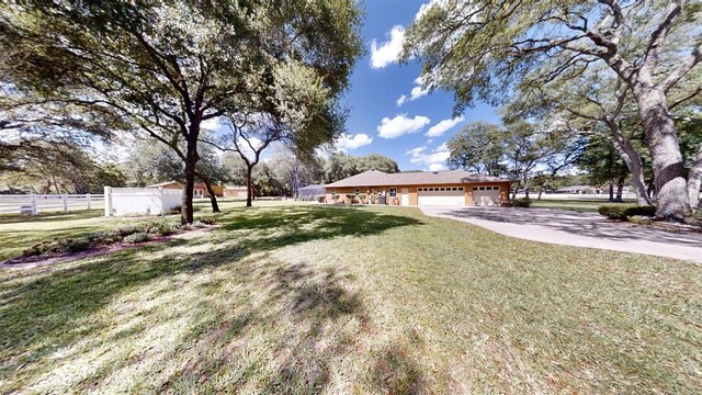10528 SW 27th Ave, Ocala, FL 34476 - view of yard with an attached garage and concrete driveway